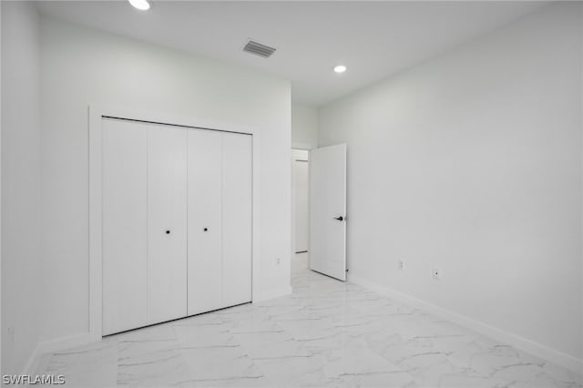 unfurnished bedroom with a closet and light tile patterned floors