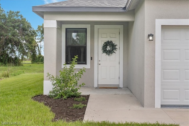 view of exterior entry featuring a yard