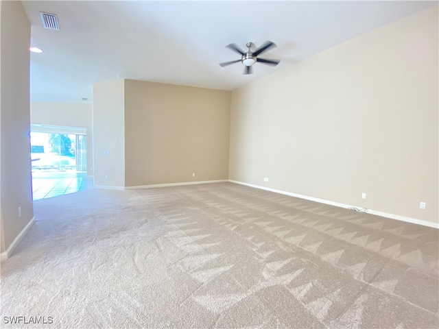 empty room featuring light colored carpet, vaulted ceiling, and ceiling fan