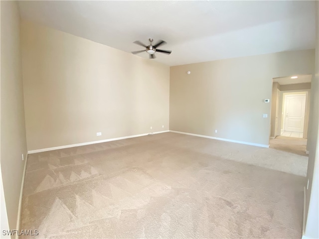 unfurnished room featuring light carpet and ceiling fan