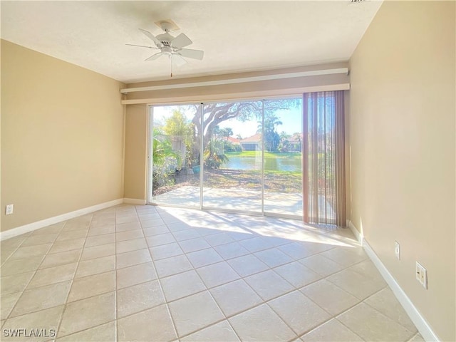4171 Los Altos Ct, Naples, FL 34109 - spare room featuring baseboards, a ceiling fan, a water view, and light tile patterned flooring