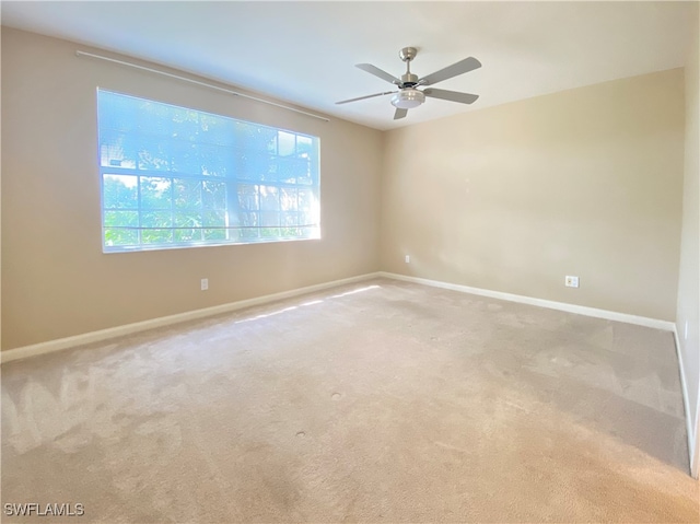 carpeted empty room featuring ceiling fan