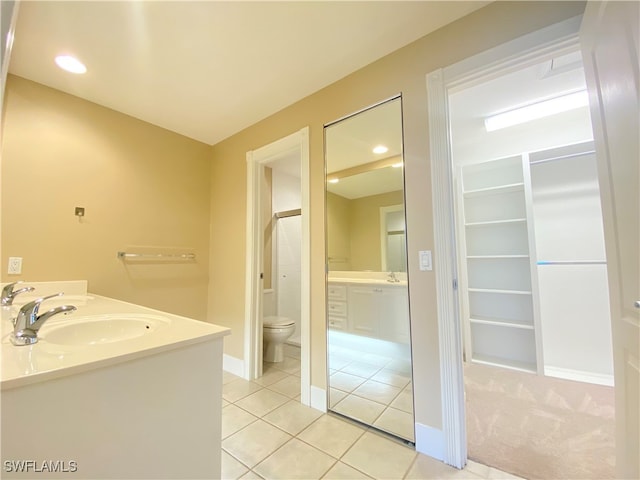 bathroom with vanity, a shower with shower door, toilet, and tile patterned floors