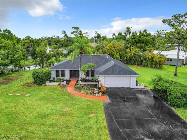 single story home featuring a garage, a front lawn, and a water view