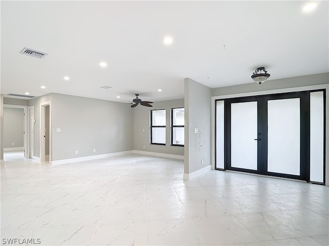 spare room featuring french doors, light tile flooring, and ceiling fan