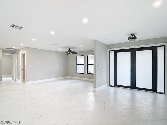 unfurnished room with french doors and ceiling fan