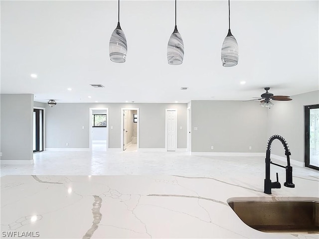 interior space featuring sink, decorative light fixtures, and ceiling fan