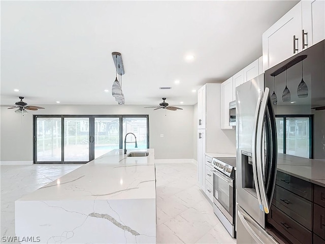 kitchen featuring pendant lighting, white cabinetry, stainless steel appliances, and sink