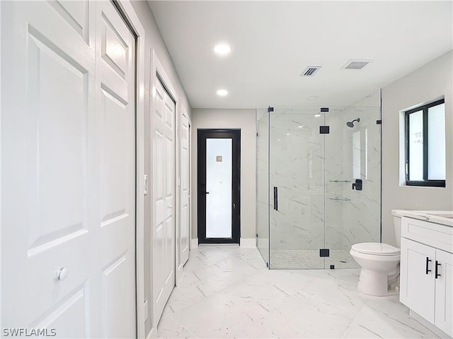 bathroom featuring vanity, toilet, and an enclosed shower