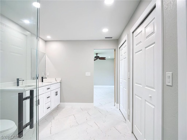 bathroom with vanity, ceiling fan, and toilet