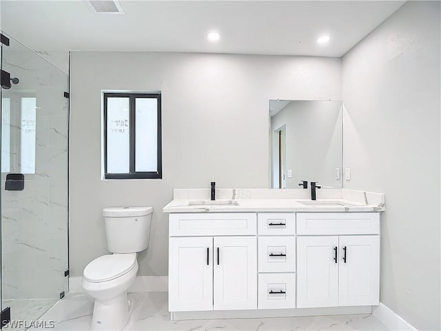 bathroom featuring vanity, toilet, and a shower with shower door