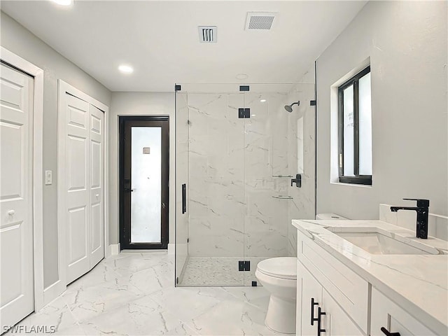 bathroom with an enclosed shower, vanity, and toilet