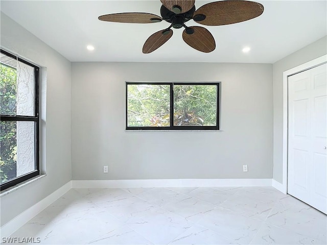 unfurnished bedroom with multiple windows and ceiling fan