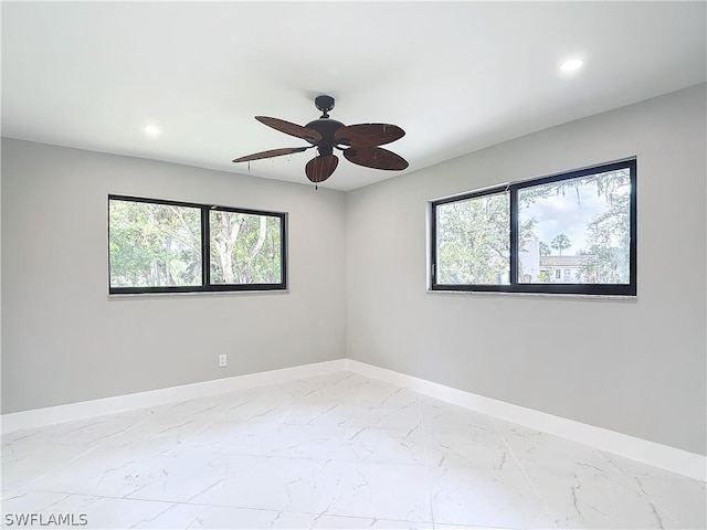 empty room featuring a healthy amount of sunlight and ceiling fan