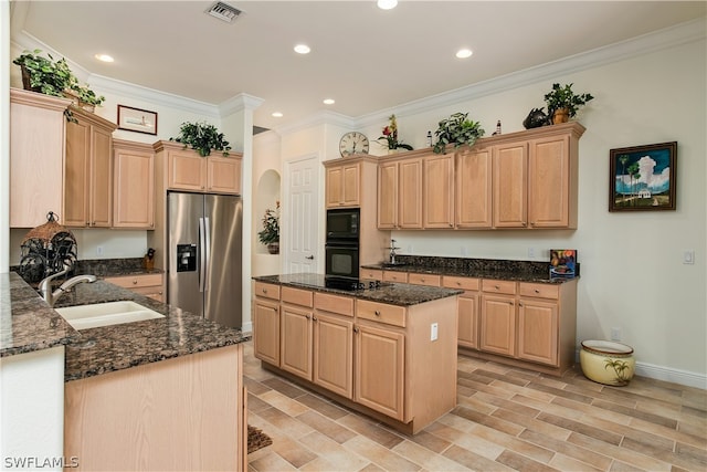 kitchen featuring light brown cabinets, black appliances, and dark stone counters