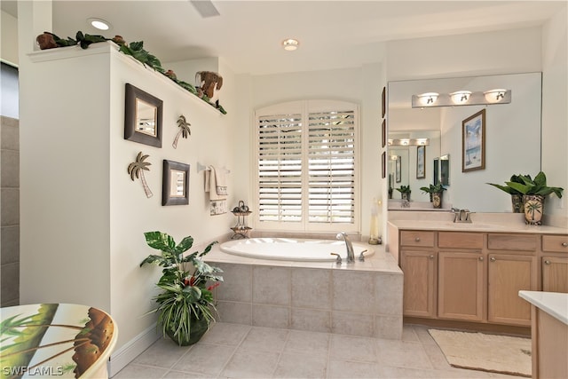 bathroom featuring tiled bath, tile patterned floors, and vanity