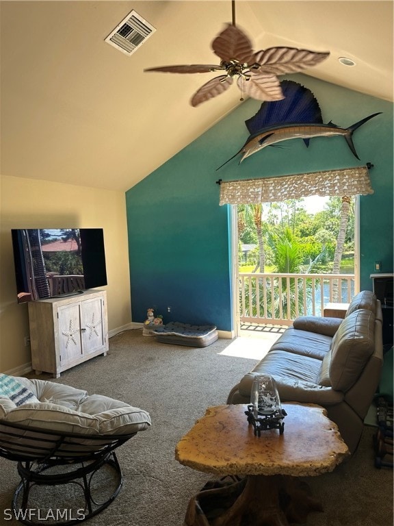 carpeted living room with ceiling fan and lofted ceiling