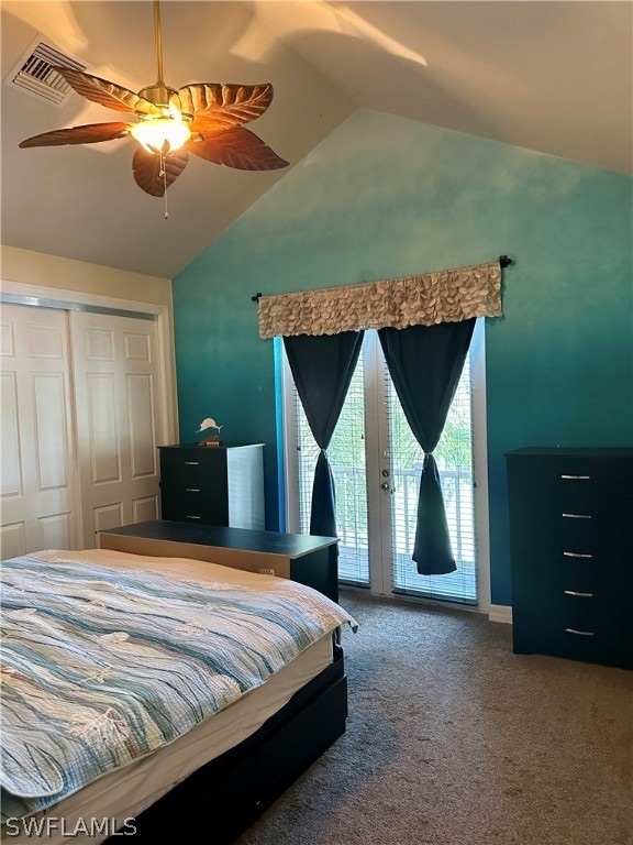 carpeted bedroom with access to outside, a closet, vaulted ceiling, and ceiling fan