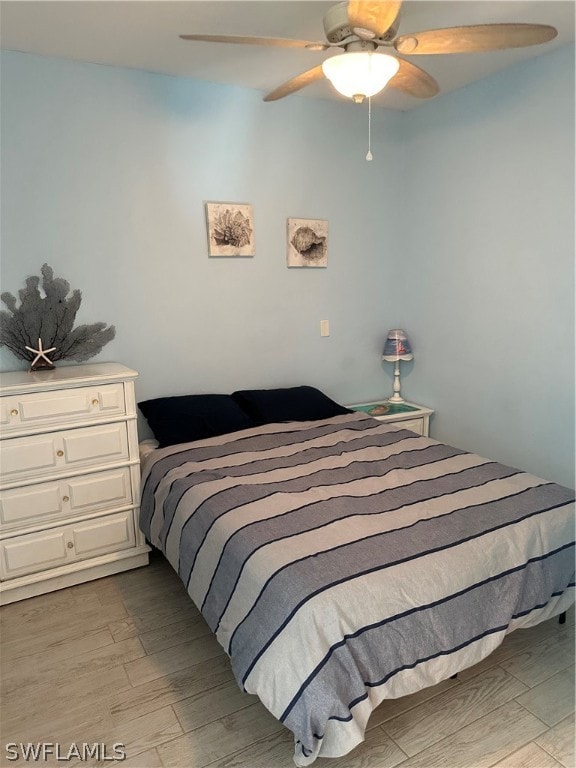 bedroom with ceiling fan and light hardwood / wood-style flooring