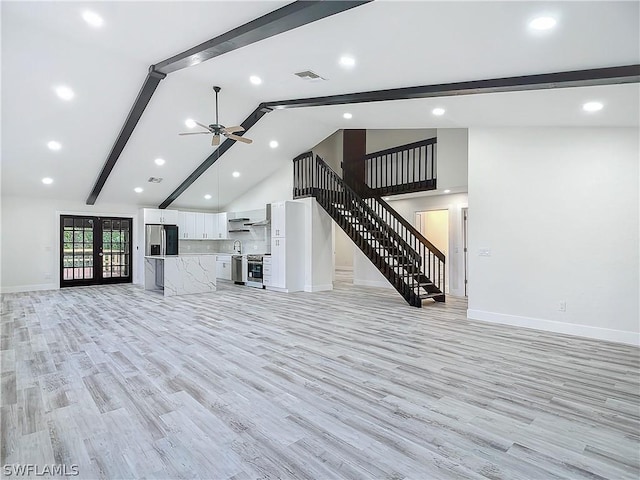 unfurnished living room featuring beam ceiling, light hardwood / wood-style flooring, high vaulted ceiling, and ceiling fan