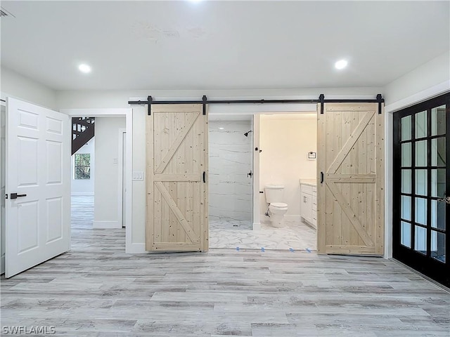 interior space with hardwood / wood-style floors and toilet