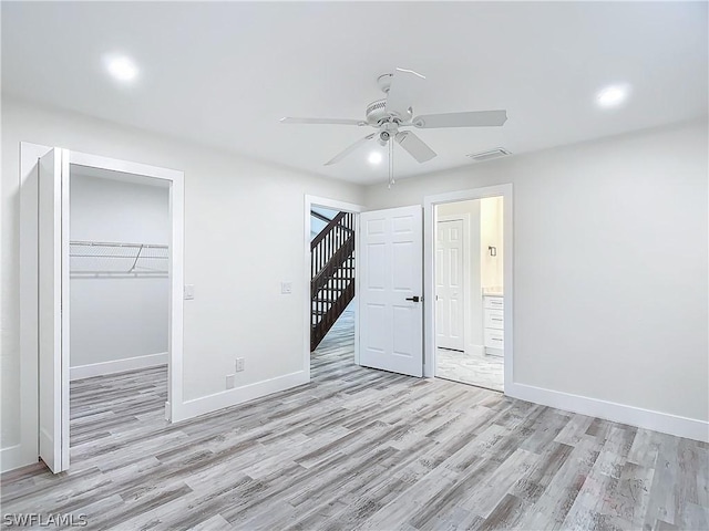 unfurnished bedroom with ceiling fan, light hardwood / wood-style floors, and a closet