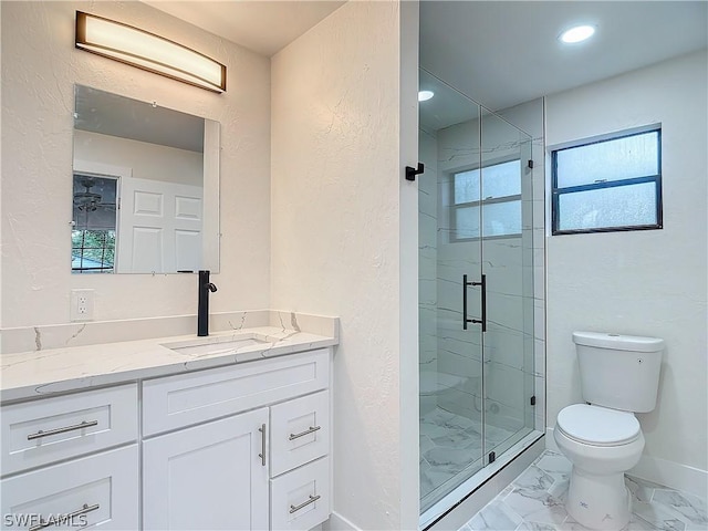 bathroom with walk in shower, vanity, and toilet