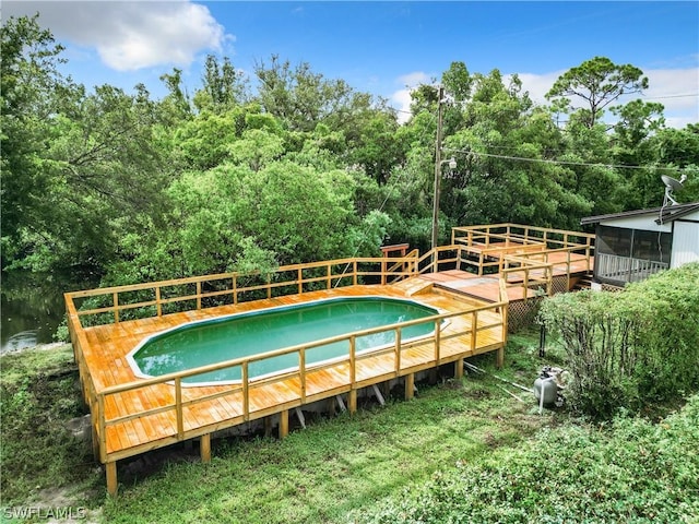 view of pool featuring a deck with water view