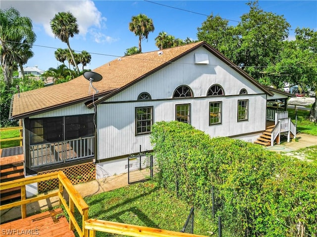 rear view of property with a sunroom