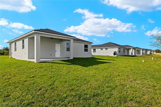 back of house with a patio, a yard, and ceiling fan