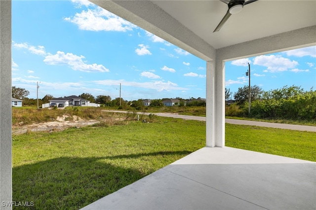 view of yard featuring a patio area and ceiling fan