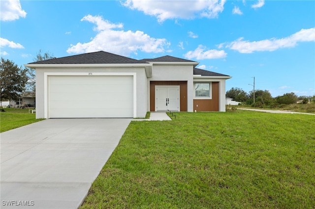 view of front of property with a front lawn and a garage