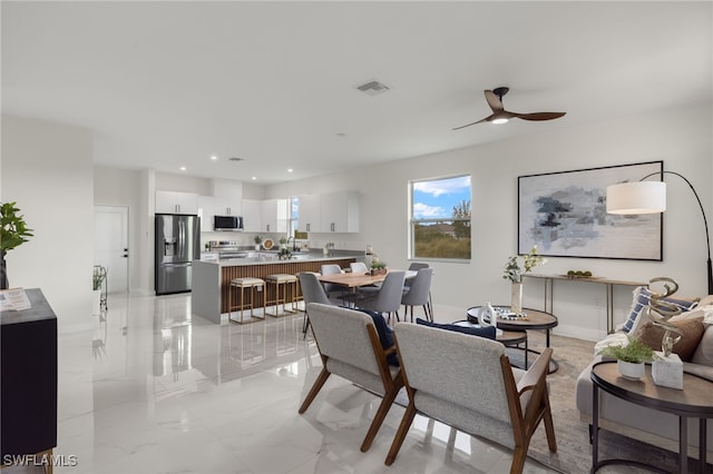 dining room featuring ceiling fan and sink