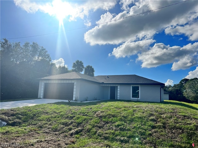 exterior space with a garage and a front lawn