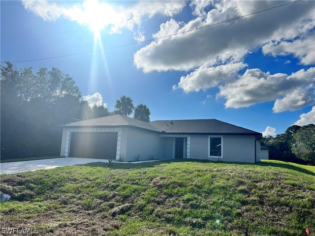 ranch-style home with a garage and a front yard