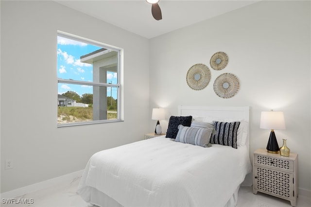 bedroom with ceiling fan and multiple windows