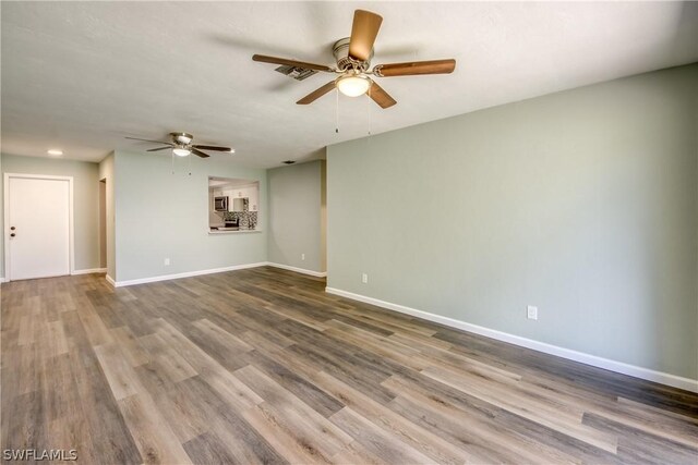 4508 Santa Barbara Blvd Unit 102, Cape Coral, FL 33914 - empty room featuring a ceiling fan, baseboards, and wood finished floors