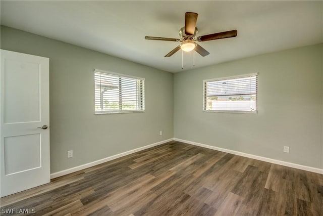 4508 Santa Barbara Blvd Unit 102, Cape Coral, FL 33914 - unfurnished room featuring healthy amount of natural light, dark wood-style flooring, and baseboards