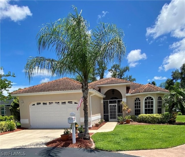 mediterranean / spanish home featuring a garage, concrete driveway, stucco siding, a tiled roof, and a front yard