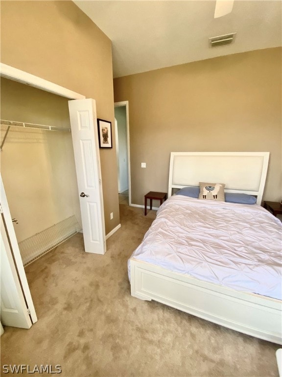 bedroom with light carpet and a closet