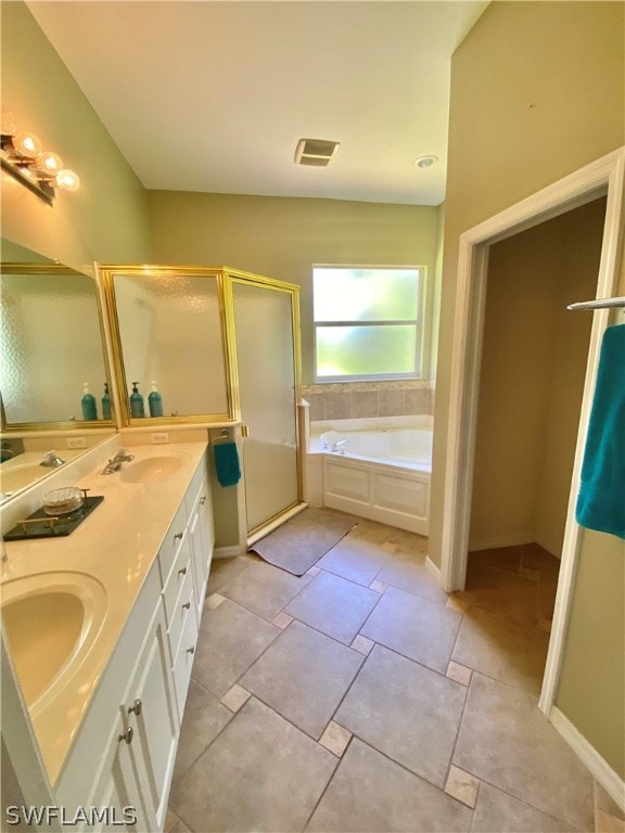 bathroom with independent shower and bath, tile patterned flooring, and vanity