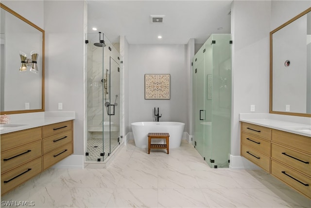 bathroom with vanity and independent shower and bath