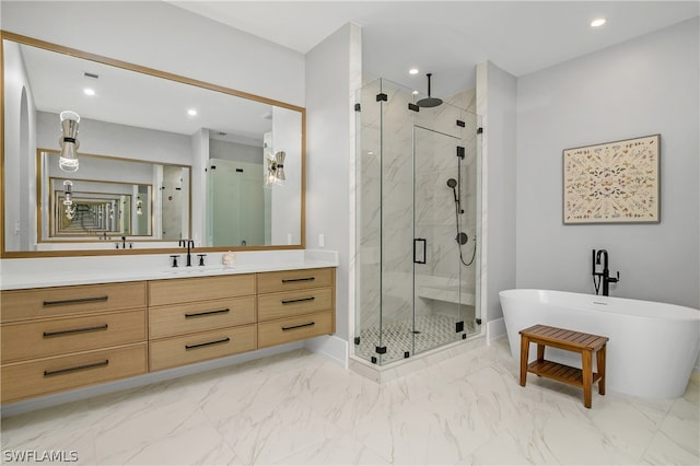 bathroom featuring vanity and shower with separate bathtub