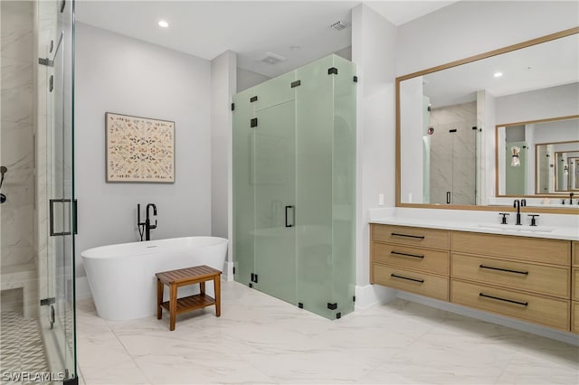 bathroom featuring vanity and shower with separate bathtub