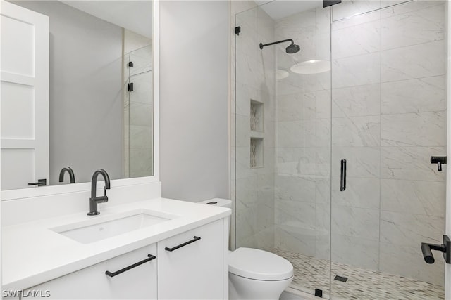 bathroom with vanity, an enclosed shower, and toilet