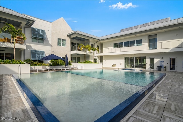 view of pool featuring a patio area and a community hot tub