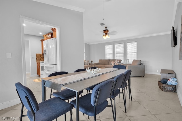 dining area with ornamental molding, light tile patterned floors, and ceiling fan