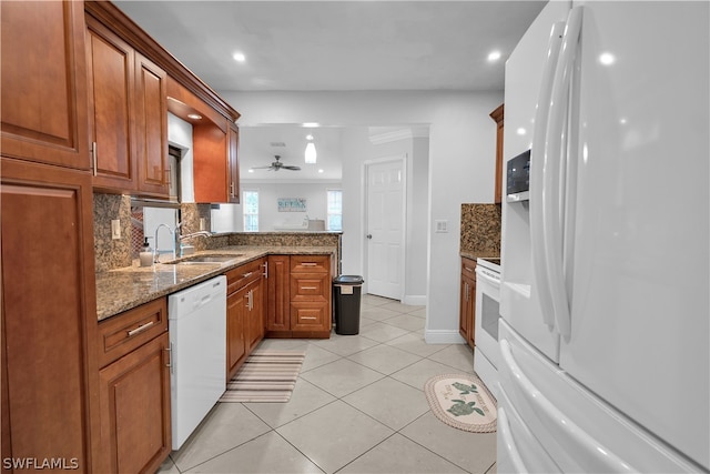 kitchen with sink, light tile patterned floors, tasteful backsplash, and white appliances