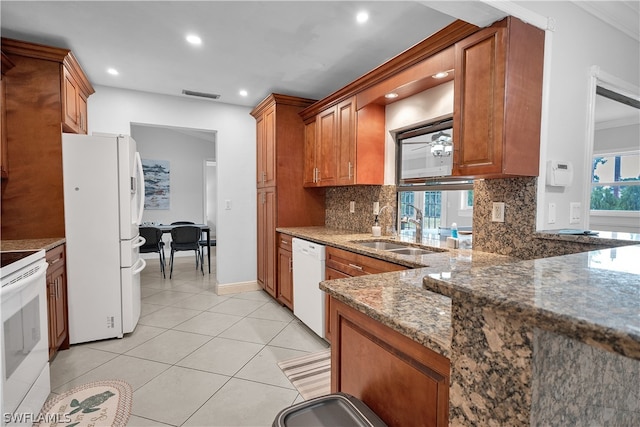 kitchen with light tile patterned flooring, tasteful backsplash, white appliances, ornamental molding, and sink