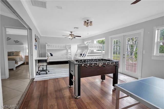 game room featuring crown molding, french doors, ceiling fan, and wood-type flooring